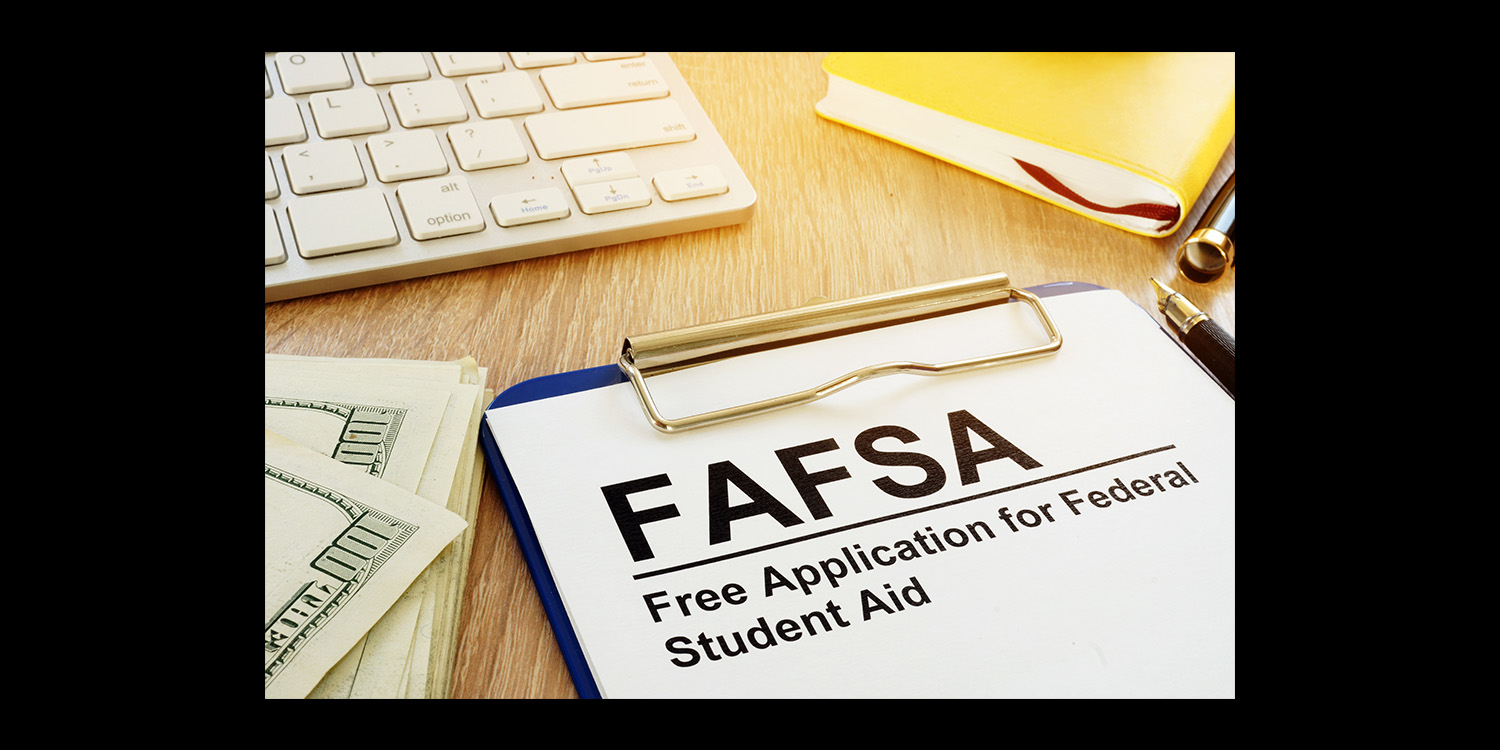 Free Application for Federal Student Aid clipboard on desk