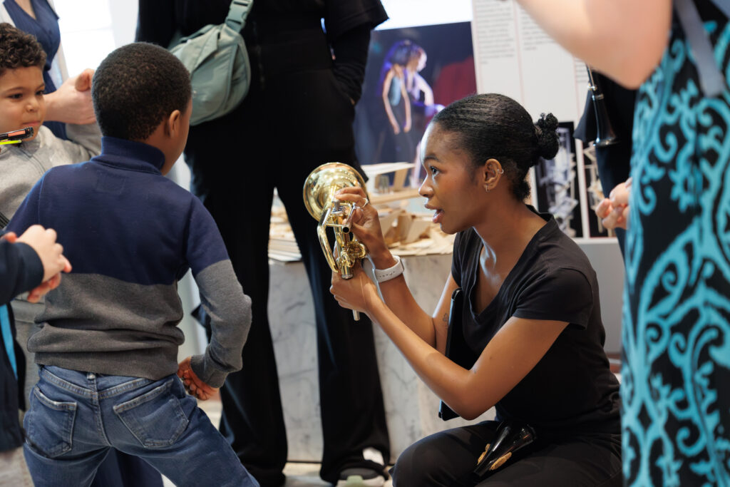 Student showing someone a trumpet at Exceptional Knights