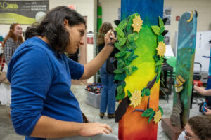 Student painting artwork at UCF.
