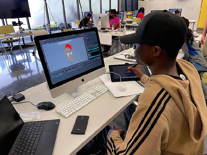 Student animating with desktop and drawing tablet