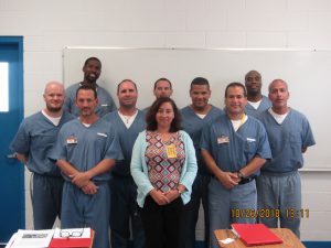 photo of 8 incarcerated students with faculty member at Central Florida Reception Center