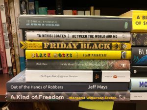 Stack of books donated to the FPEP Social Justice Library