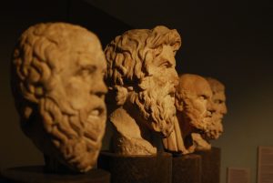 A row of statues depicting ancient Greek philosophers.