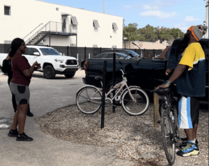 Kierrah uses sign language to speak with a homeless individual at the CSC