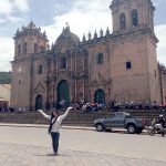 Student on a study abroad trip in Peru in front of a church