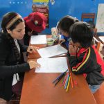 Student teaches young children on a study abroad trip in Peru
