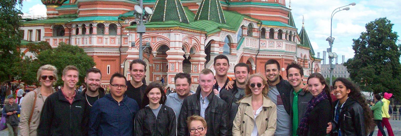Study abroad students pose in front of a kremlin