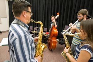 Faculty and staff play their instruments