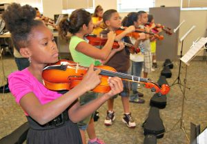 Students learn violin from A Gift For Music