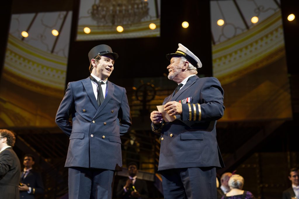 Mark Brotherton performs in Titanic the Musical as the captain next to student Austin Branks