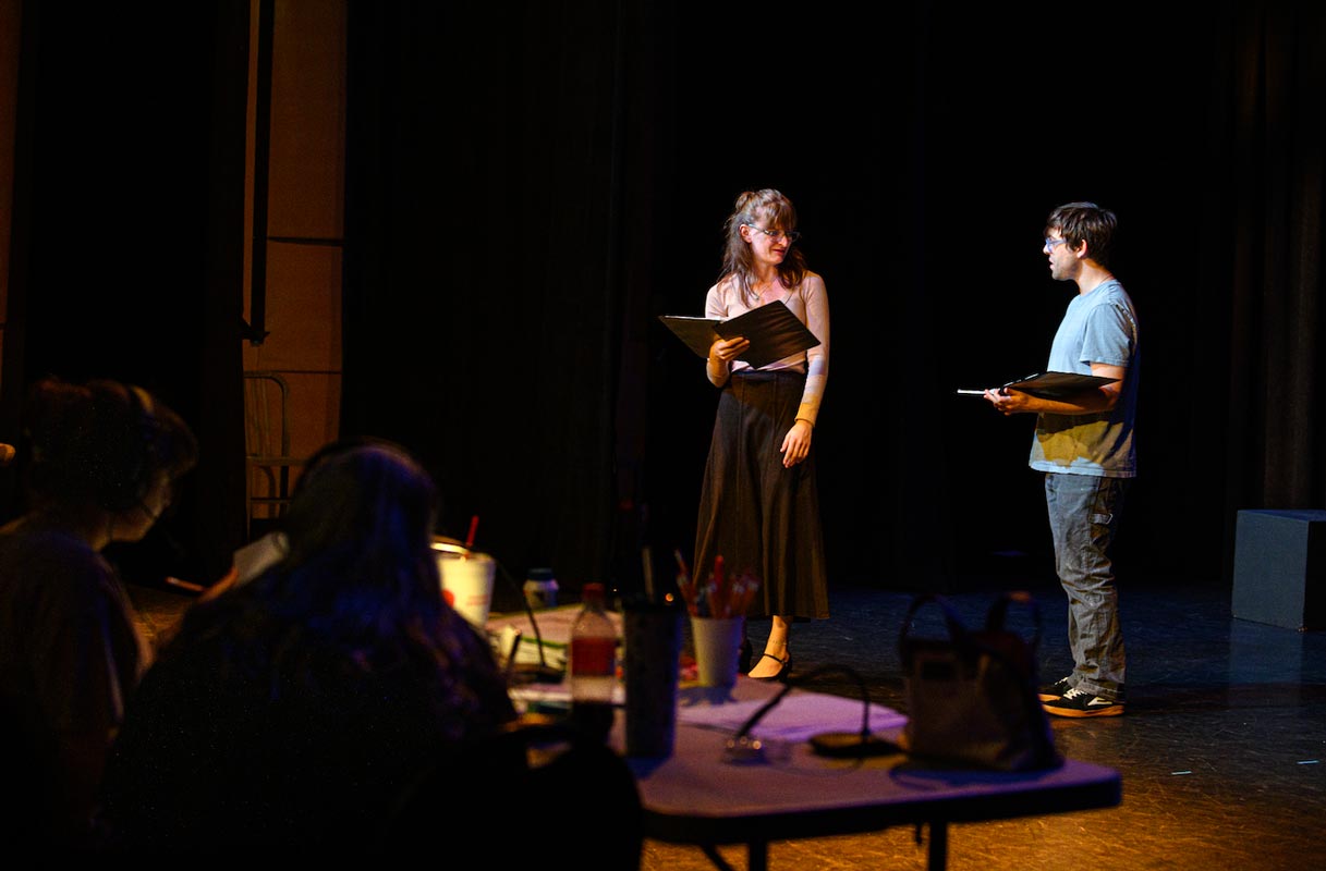 Two student actors reading a play