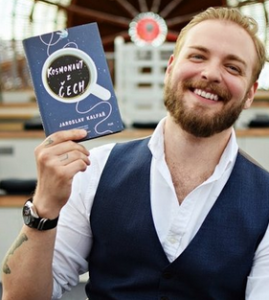 Author Jaroslav Kalfar posing with his book Spaceman of Bohemia