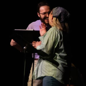 Two actors laugh together while workshopping a new play, Public Wickedness by Lee Osario.