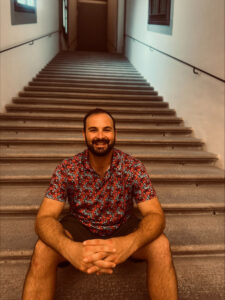 Man sits on stairs.