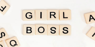 Scrabble titles spell GIRL BOSS