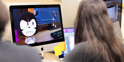 Student views animation frame with cartoon cats on desktop computer