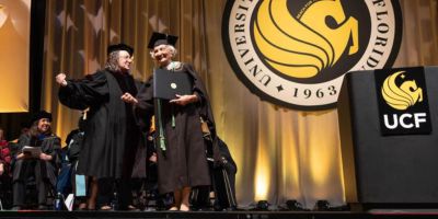 Virginia Perwin ’22MA (right) with Dean of the College of Graduate Studies Elizabeth Klonoff (right) on the commencement stage