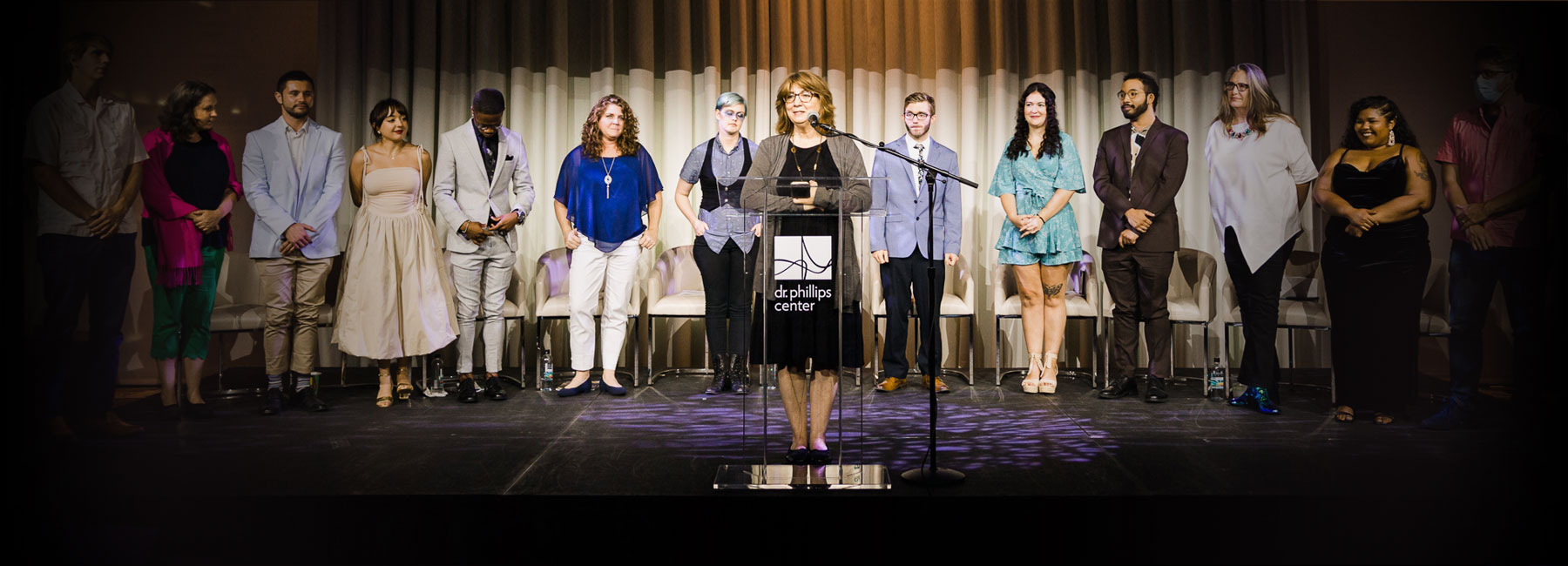 Creative writing students and faculty on stage