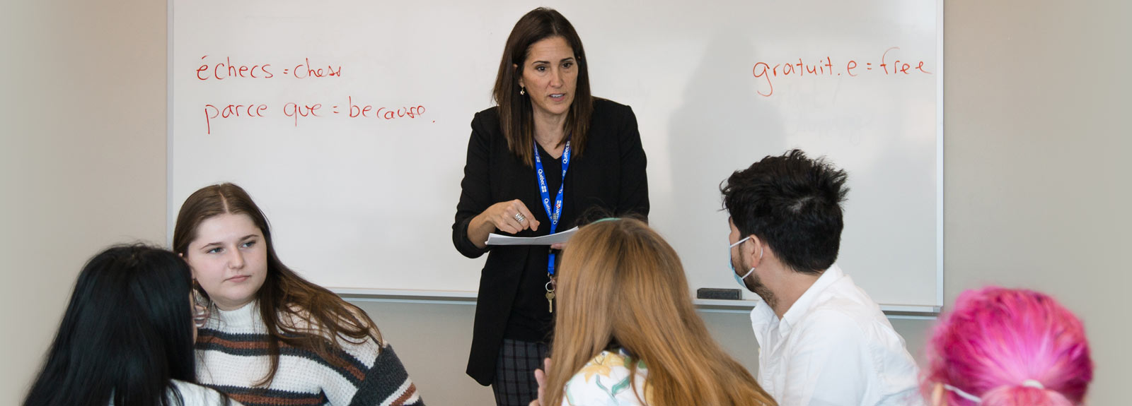 Instructor teaching French to students in classroom