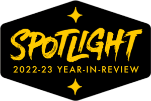 Shield with stars and 'SPOTLIGHT 2022-23 Year-In-Review'