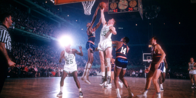 Wilt Chamberlain (#13) of the Philadelphia Warriors fights for the rebound