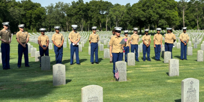 Photo of Veterans standing together in a graveyard