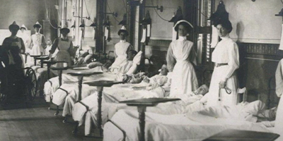 Photo of WWII nurses next to their patients