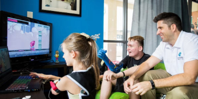 Professor Matt Dombrowski and two teens with custom prosthetics