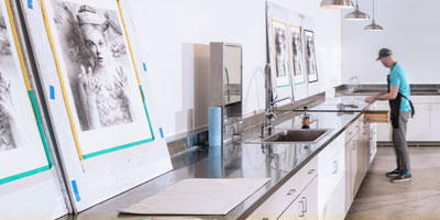 Artist works in Flying Horse Editions' printmaking studio