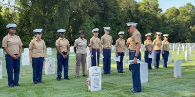 Veterans standing over gravestones