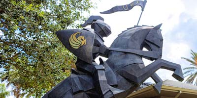 Statue of knight on horseback with UCF shield