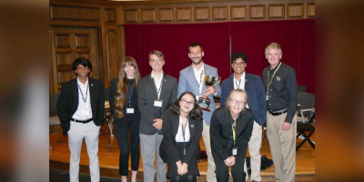 The UCF Ethics Bowl Team pictured with trophy
