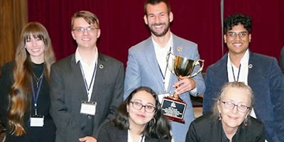 UCF Ethics Bowl team poses with trophy
