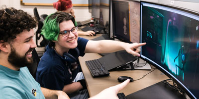 Student animators point at screen