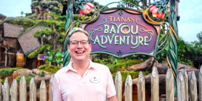 Alum Corey Clancy stands in front of Walt Disney World’s Bayou Adventure.