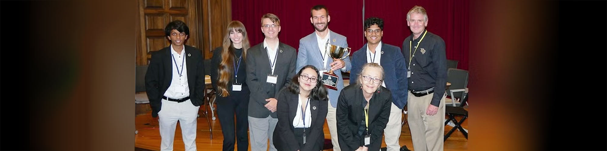 UCF Ethics Bowl team poses with trophy
