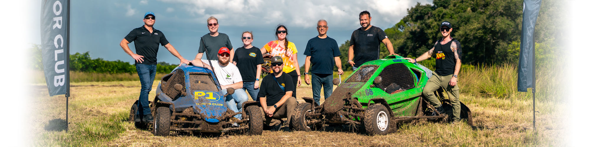 Themed Experience students pose with a motor racing team