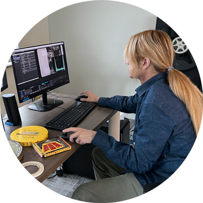 Student uses computer workstation to scan old film