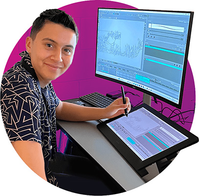 Young person uses drawing tablet in front of computer screen