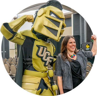 Knightro flexes with faculty member