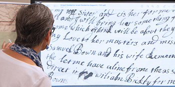 Person looks at old handwritten script on screen