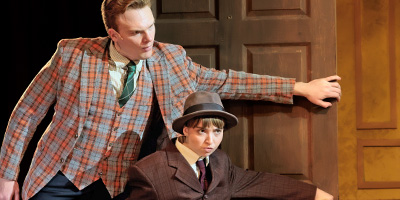 Two actors open a door with exaggerated affect