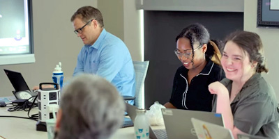 Students, staff and faculty work in conference room
