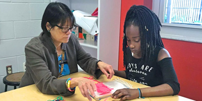 Stella Sung instructs child