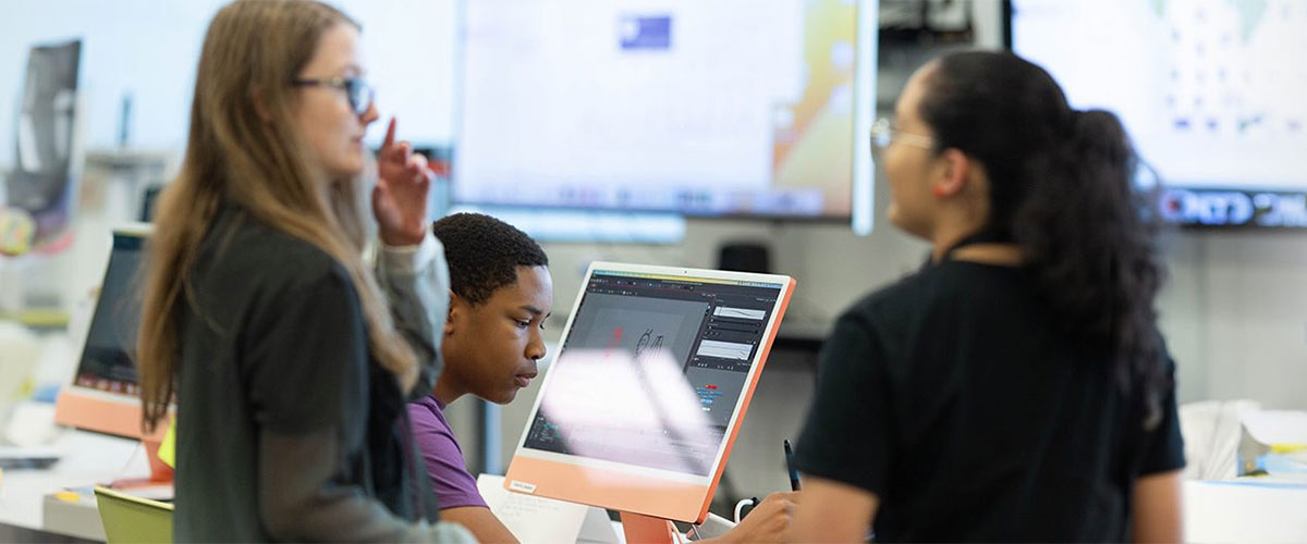 Young students converse in computer lab