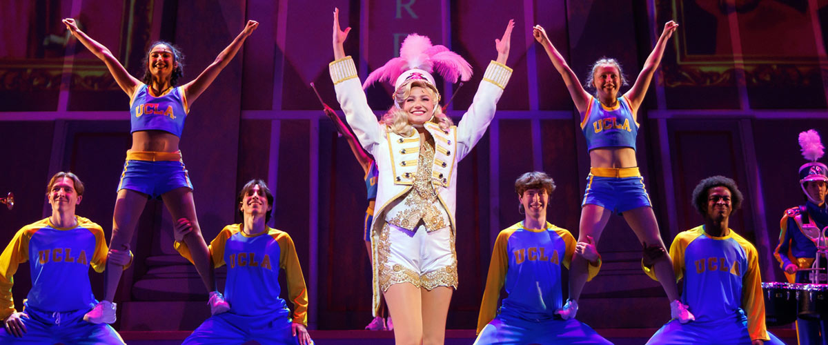 Colorfully dressed cast of Legally Blonde perform on stage