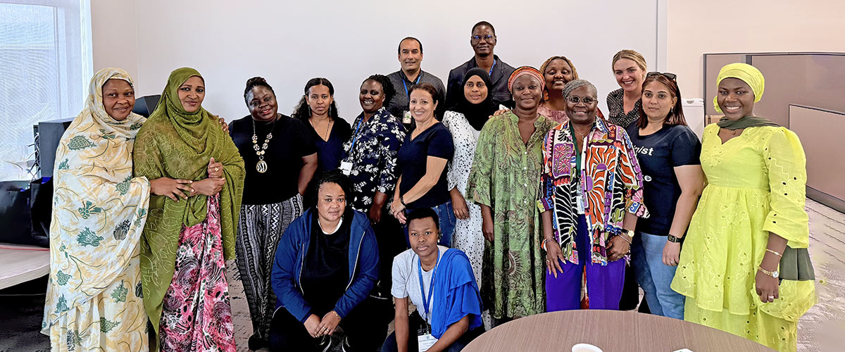 Large group poses together in an office space