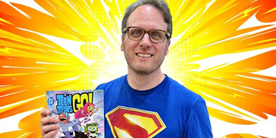 Luke Cormican holds a copy of the 'Teen Titans GO!' comic book