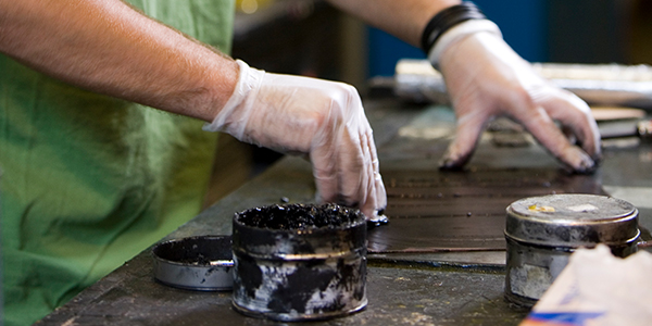 Student inking a plate in print lab