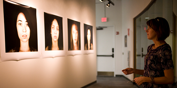 Student in gallery looking at photographs